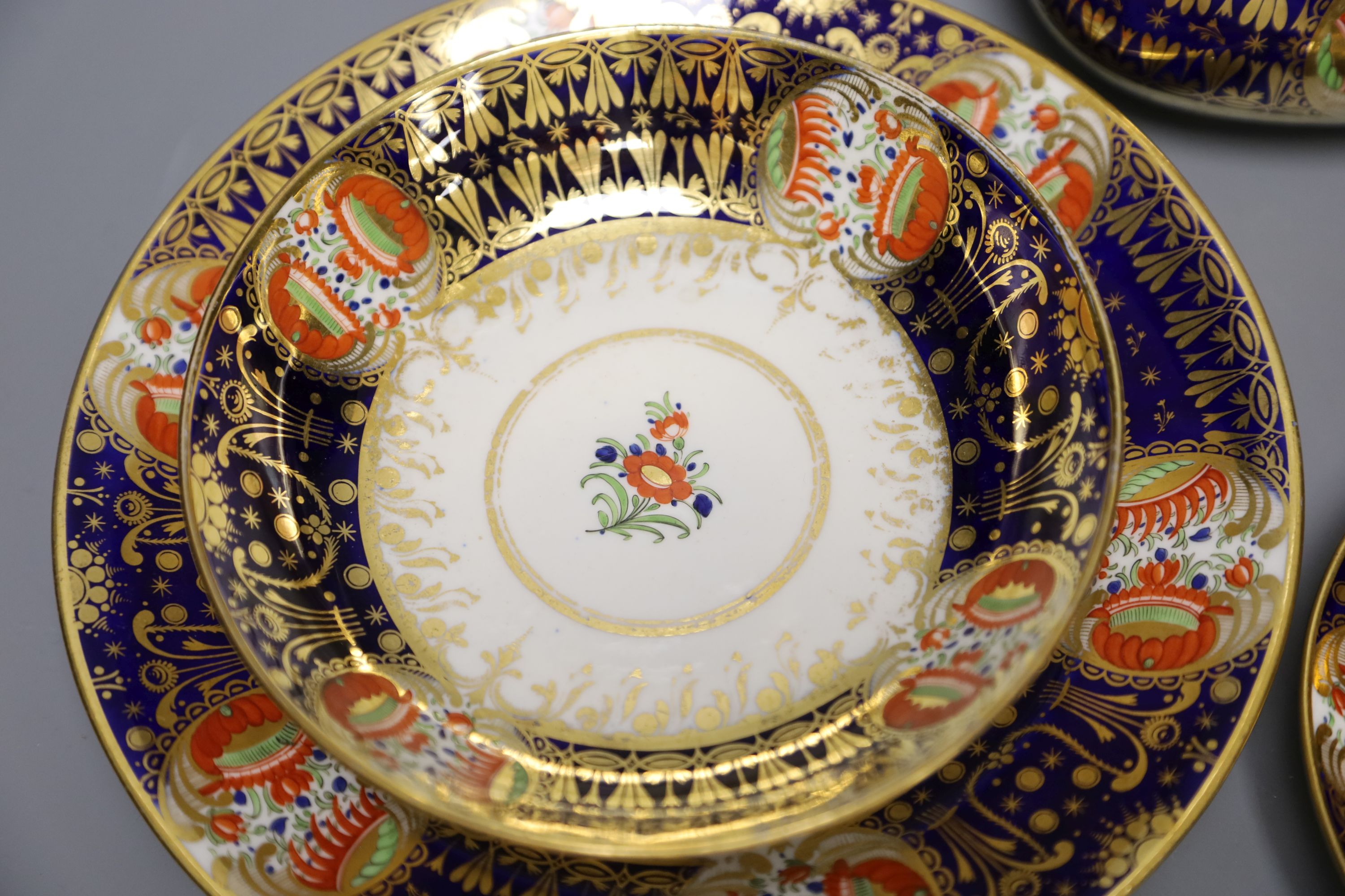 An early 19th century Chamberlains Worcester imari-style graduated set of three cups and saucers, a plate and a sucrier and